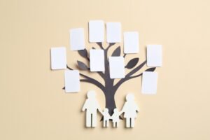family tree and people figure on beige background, top view